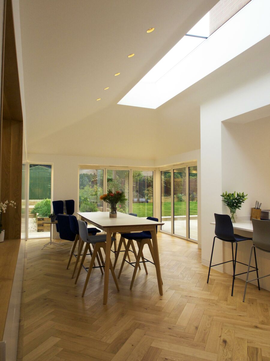 Modern dining room with hidden cabinetry flooded with natural light..