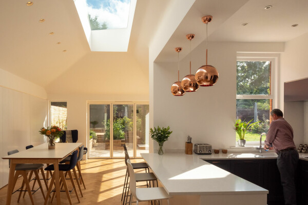 Modern kitchen and dining room flooded with natural light..