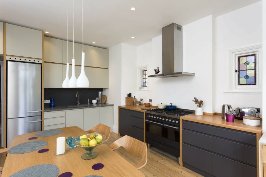 Modern kitchen with a mixture laminated plywood & sprayed fronts and concrete & solid oak worktops..