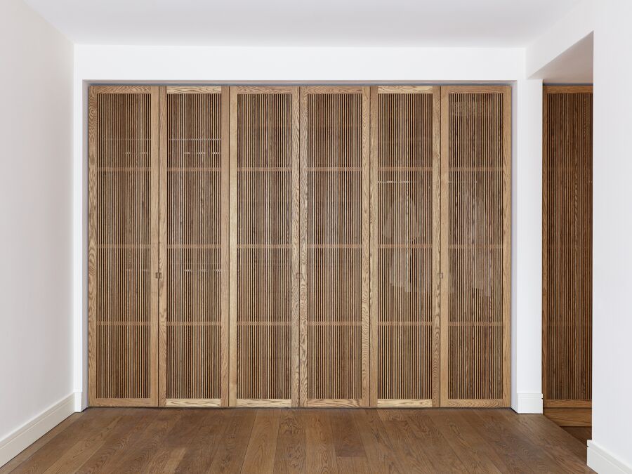 Master bedroom wardrobe with solid oak slatted doors..
