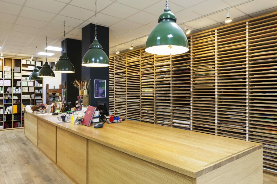 Shepherds of London large solid oak shop counter and paper display racks.