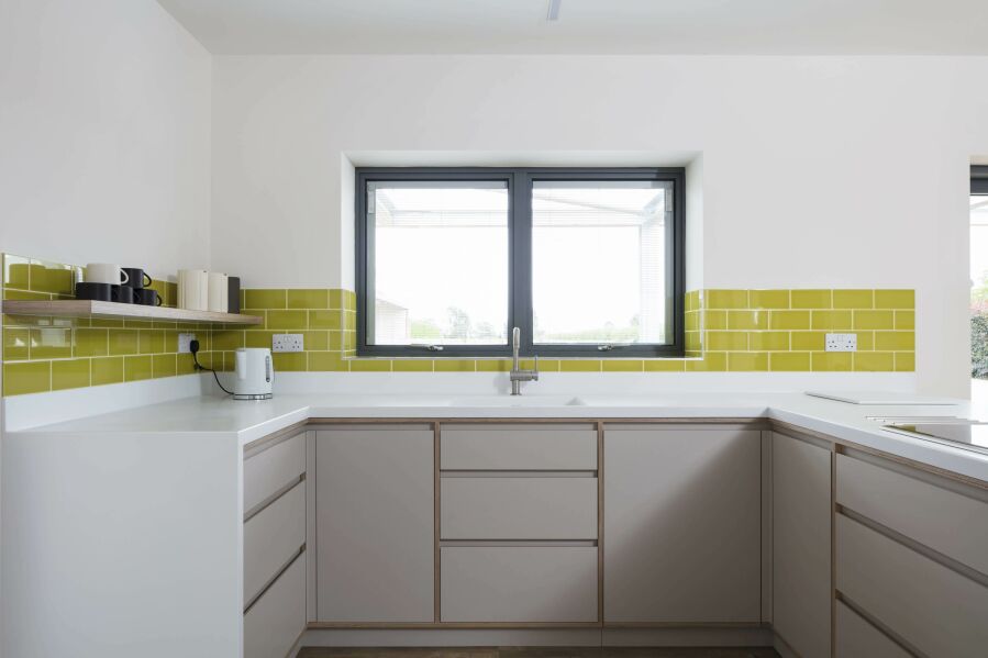 Modern kitchen with laminated birch plywood fronts and Corian worktops..