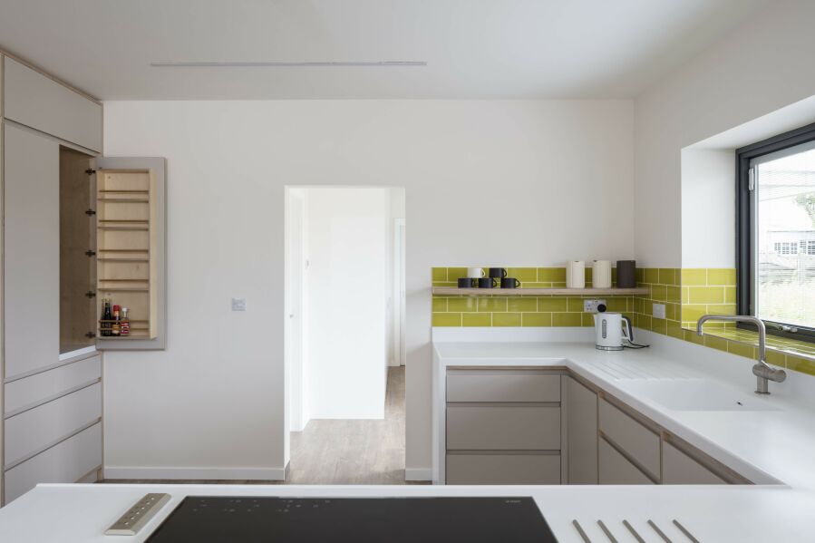 Modern kitchen with laminated birch plywood fronts and Corian worktops..