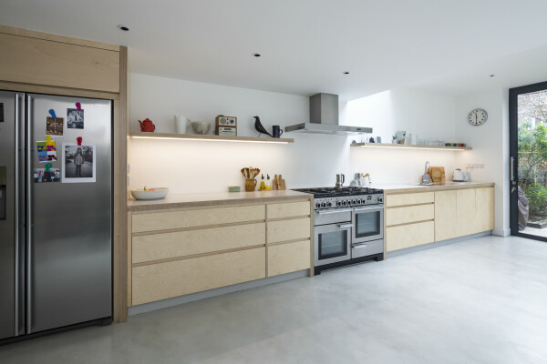 Modern plywood kitchen with a polished concrete floor.